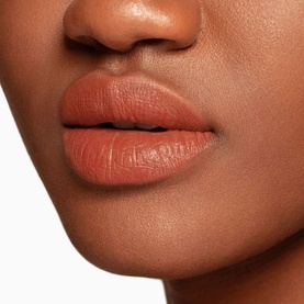 Model wearing NARS Air Matte Lip Colour in Morocco, a warm terracotta-brown matte shade, 7.5ml