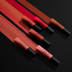 NARS Air Matte Lip Colour collection of five pencils in shades ranging from nude to red, displayed fanned out on dark background