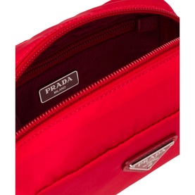 Prada Accessories Nylon Pouch in red, open to show interior, with silver enamelled triangle logo and zip closure visible