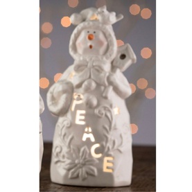 Belleek Peace Snowman Votive in white porcelain with glowing PEACE lettering, LED light illuminated, bokeh lights in background
