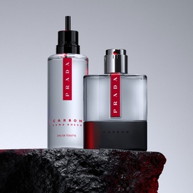 Prada Beauty Luna Rossa Carbon Eau de Toilette 50ml bottle and refill bottle displayed on dark stone surface