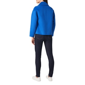 Model wearing Hobbs Rosanna Wool Blend Coat in blue, rear view, with dark skinny jeans and white trainers