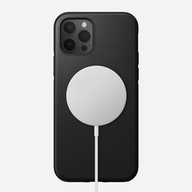 Nomad Rugged Case MagSafe iPhone 12/12 Pro in black, shown with MagSafe charger attached to rear of case