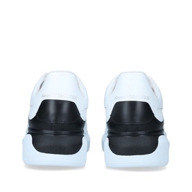 Alexander McQueen Show Drop Tab Trainers in white leather with black heel tab and chunky white sole, rear view