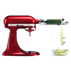 KitchenAid Spiralizer Attachment fitted to a red stand mixer, spiralizing courgette into thin ribbons into a white bowl