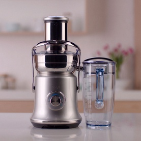 Sage Cold XL Nutri Juicer in brushed grey stainless steel, shown with detached clear juice jug on kitchen counter