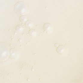 Sarah Chapman Platinum Stem Cell Elixir serum texture close-up showing lightweight oil droplets on a cream surface