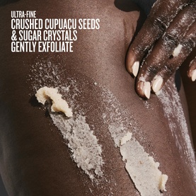 Sol De Janeiro Bum Bum Body Scrub applied to skin, showing crushed cupuacu seeds and sugar crystal exfoliating texture