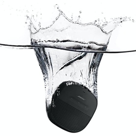 Bose Soundlink Micro Speaker in black submerged in water, demonstrating waterproof capability with dramatic splash effect