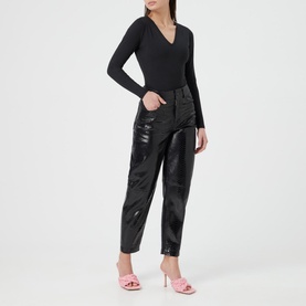 Model wearing Spanx Suit Yourself V-Neck Bodysuit in black with black patent trousers and pink heeled mules