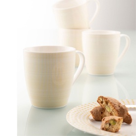 Aynsley Spots and Dots Set of 4 Mugs in yellow, shown with textured detailing, styled with biscotti on a coordinating plate