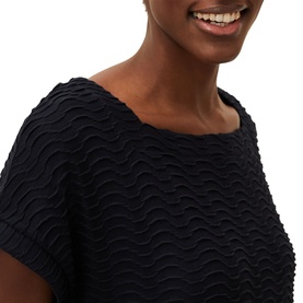 Model wearing Phase Eight Starla Textured Tunic Dress in blue, close-up showing wave-textured fabric and scoop neckline with short sleeves