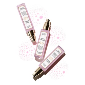 Sunday Riley Pink Drink hydrating treatment serum in pink pump bottles with gold tops, three bottles shown scattered on white background