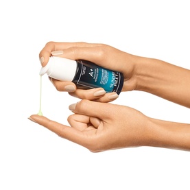 Sunday Riley A+ High-Dose Retinoid Serum being dispensed from pump bottle onto open palm, showing pale yellow serum texture