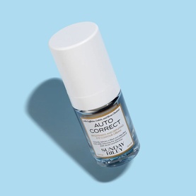 Sunday Riley Auto Correct eye care serum in clear glass bottle with white cap, on light blue background