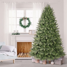 Puleo Kensington Fir Tree 7.5ft artificial Christmas tree with full green branches, styled in a bright living room with wrapped gifts at base