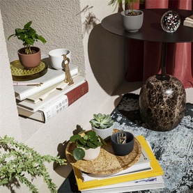 Jasper Conran Jasper Folia Terracotta Mini Pot in multi, small decorative pot styled on a cork trivet with books and succulents nearby