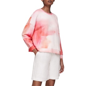 Model wearing Whistles Tie Dye Cotton Sweatshirt in pink with white shorts. Relaxed fit, crew neck, dropped shoulders