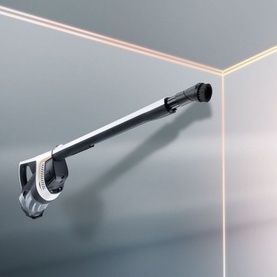 Miele Triflex HX1 Cordless Vacuum Cleaner in white, shown in wand configuration cleaning a ceiling corner junction