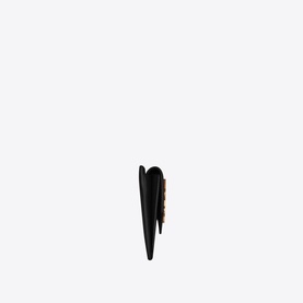 Saint Laurent Uptown Embossed Leather Card Case in black grain de poudre leather, shown from the side, with gold YSL monogram detail