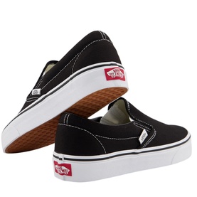 Vans Classic Slip-On Trainers in black canvas with white sole, elastic side accents and signature red Vans logo tab, shown from rear angle