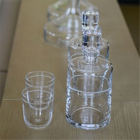 Vera Wang Bande Tumbler Set of 2, clear crystalline glass tumblers styled alongside a matching decanter on a wooden surface