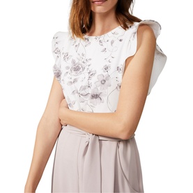 Model wearing Phase Eight Victoriana Printed Jumpsuit in cream, featuring floral print bodice and short ruffle sleeves. Tied waist detail visible