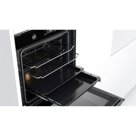 Whirlpool W Collection Built-In Electric Oven open door view showing interior wire rack, baking tray, and black cavity lining