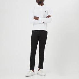 Model wearing Ralph Lauren Long Sleeve Slim Fit Polo Shirt in white with black trousers and white trainers, arms crossed