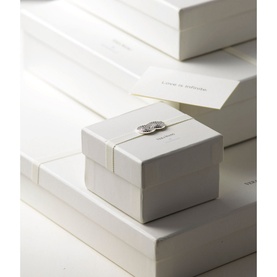 Wedgwood Infinity Small Photo Frame in white gift box with silver bow detail, surrounded by stacked white branded boxes