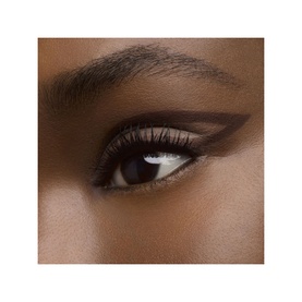 Model with YVES SAINT LAURENT Crushliner Waterproof Liner applied as a precise dark brown winged liner look on deep skin tone