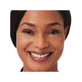 Model with IT COSMETICS Bye Bye Under Eye Concealer applied, showing smooth, even coverage under the eyes on deep skin tone