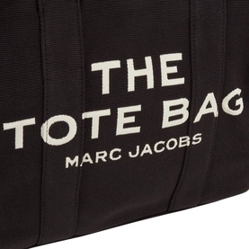 Marc Jacobs The Jacquard Large Tote Bag in black, close-up of woven logo lettering detail on cotton-blend fabric