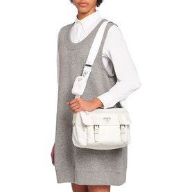 Model carrying Prada Accessories Re-Nylon Shoulder Bag in white with silver hardware and removable zipper pouch