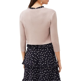 Model wearing Phase Eight Salma Light Knit Jacket in cream, crop length with 3/4 sleeves, styled over a navy polka dot skirt, back view