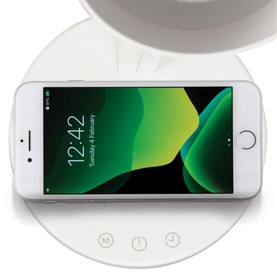 iStar Wireless Charging Lamp in white, shown charging a smartphone, with control buttons on the base and lamp visible above