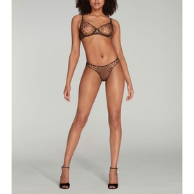 Model wearing Agent Provocateur Lucky Leopard Sheer Underwired Bra in brown leopard-print mesh, styled with matching briefs and black heels