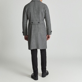 Model wearing Reiss General Houndstooth Double-Breasted Coat in black, back view, styled with black trousers and chunky shoes