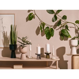 Iittala Nappula Pillar Candle Holder 107mm in moss green, styled on a wooden shelf with candles, plants and complementary home accessories