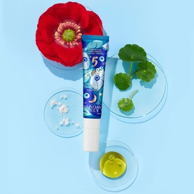Sunday Riley Retinoid + Niacinamide Eye Serum in blue illustrated tube, styled with red poppy flower and botanical ingredients on blue background