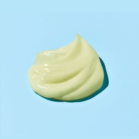 Sunday Riley Retinoid + Niacinamide Eye Serum pale green cream texture swatch on light blue background