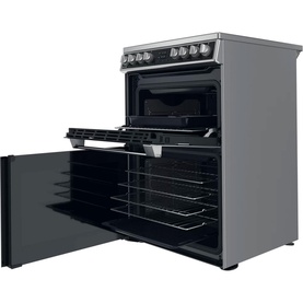 Hotpoint Electric Freestanding Double Cooker 60cm in silver, with lower oven door open revealing black interior and wire shelves
