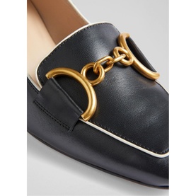 LK Bennett Samantha Snaffle Block Heels in black leather, close-up of gold snaffle chain hardware detail with cream piping trim