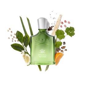 Creed Original Vetiver Eau de Parfum green glass bottle surrounded by fresh botanicals including vetiver, citrus and spice ingredients