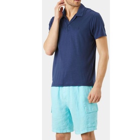 Model wearing Vilebrequin Pirinol Polo Shirt in navy, short sleeves, open polo collar, styled with light blue cargo shorts