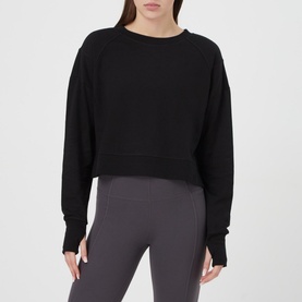 Model wearing Sweaty Betty After Class Cropped Sweatshirt in black, styled with dark grey leggings