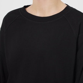 Model wearing Sweaty Betty After Class Cropped Sweatshirt in black, showing crew neck and raglan sleeve detail