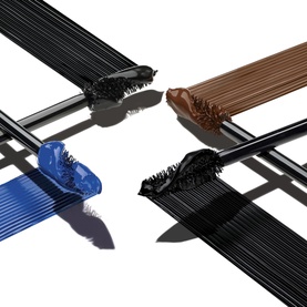 Yves Saint Laurent Lash Clash Extreme Volume Mascara wands in four shades: black, blue, brown, and dark, fanned out on white background