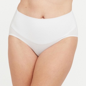 Model wearing Spanx Cotton Comfort Light Control Briefs in White, high-waist brief with smooth front panel and double-layer waistband