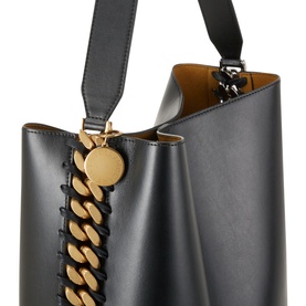 Stella McCartney Frayme Chain Tote Bag in black with gold-tone chunky chain detail, open top, and shoulder strap. Tan interior visible